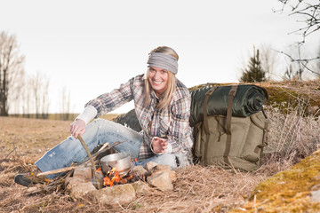 Campfire hiking woman with backpack cook countryside