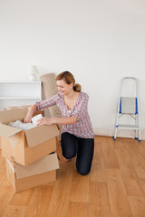 Beautiful blond-haired woman preparing to move house