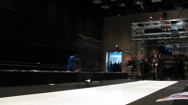 empty fashion model podium and people near