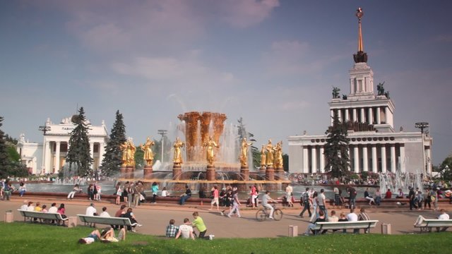People near fountain at summer day