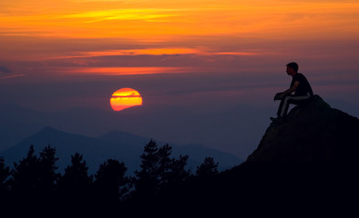 Fototapeta premium Man silhouette on the sunset background