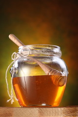 Pot of honey and wooden stick in it