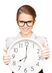 woman holding big clock