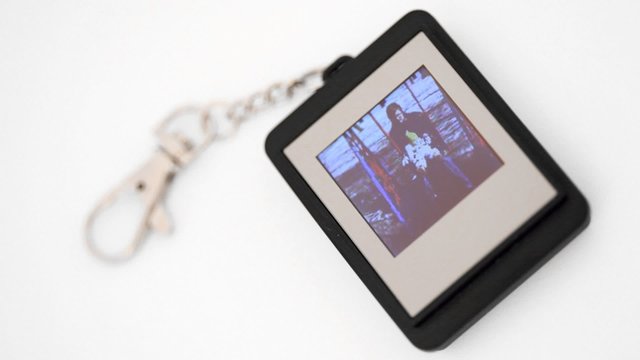 trinket with liquid-crystal display showing family photos