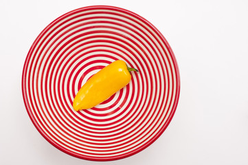 fresh chili peppers in red and white spiral bowl