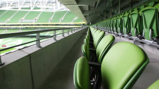 Green seats of stadium, solar day, rotating camera.