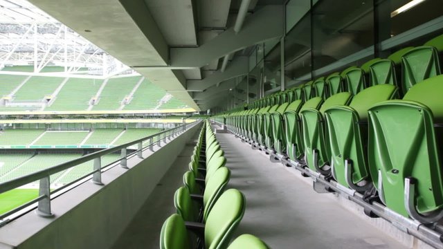 Green seats of the stadium, bright cloudless day.