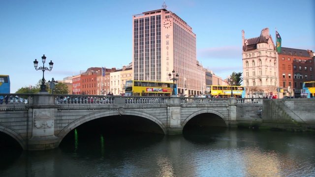 Cars and passer-by on O'Connell bridge on Liffey bridge