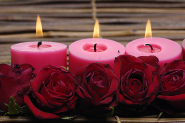 Red candlelight with rose on mat