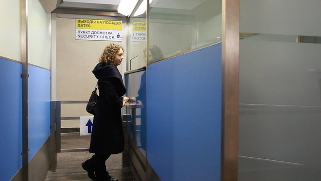 woman standing at window airport security checkpoint