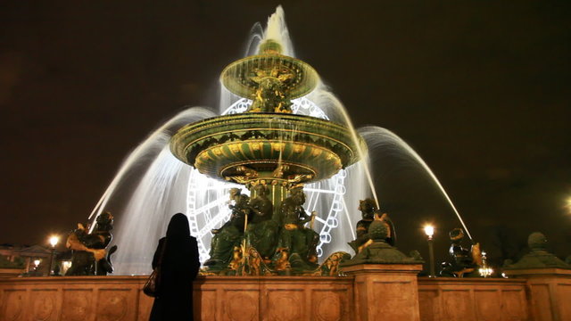 woman at fountain des Mers on Place de la Concorde in Paris