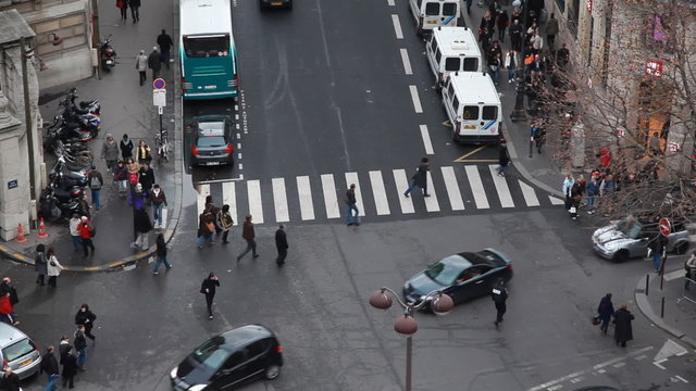 traffic at intersection and crosswalk in center of Paris by day