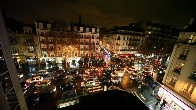 traffic of machines at crossroads in Paris illuminated by night