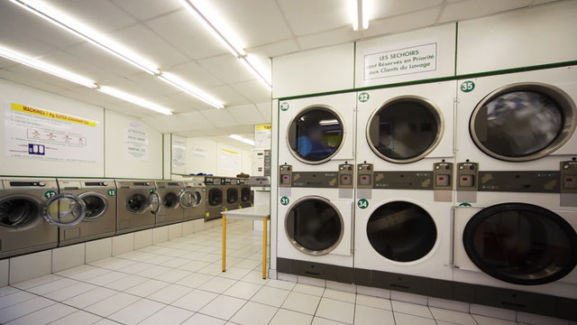 public laundry with washing machines, one of them shove clothes