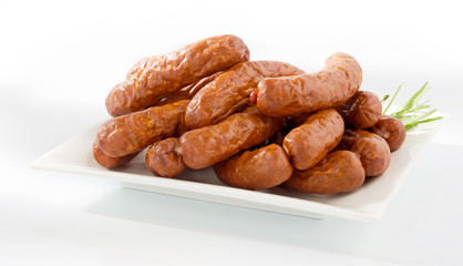 Fresh peasant sausage on a plate isolated on white background