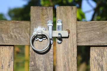 Close up closed latched wooden gate