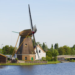 Dutch windmill, house and bridge