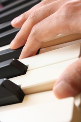 fingers playing the piano