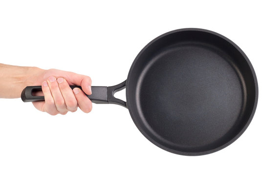Frying pan in a hand isolated on white background