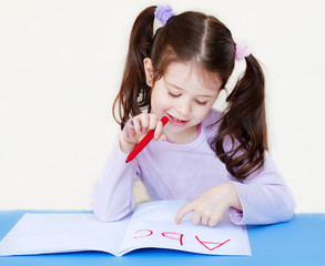 Child writing the abc