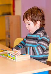 Child playing a table game in kindergarten