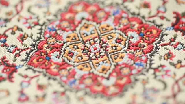 closeup of ornament on the carpet, pattern rotates