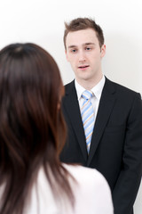 a young businessman talking to woman