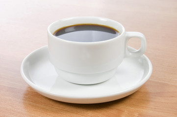 Cup of black coffee on a wooden table