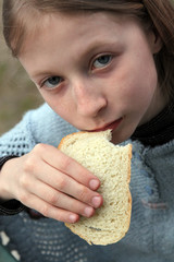 A child holding a piece of bread