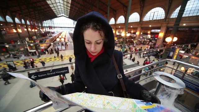 woman looks at map in Paris North Station