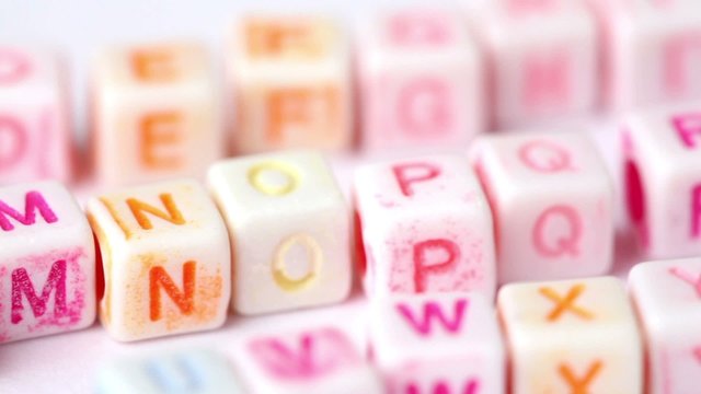 row white blocks with colored letters on white backdrop