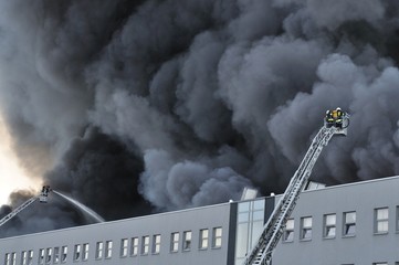 Firefighters fighting a fire at a warehouse