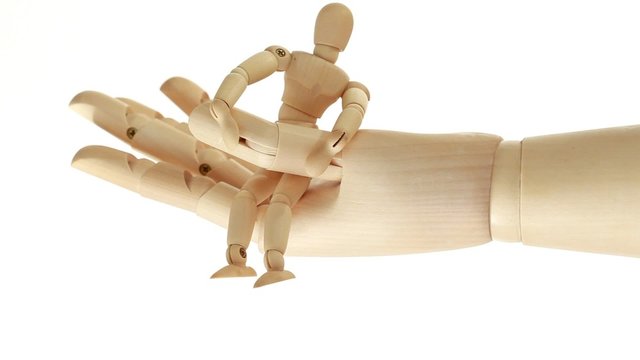 rotation of wooden toy giant arm with little toy man