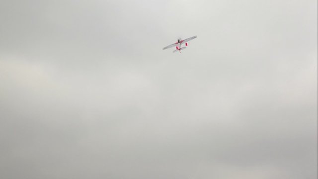 Toy model airplane start flying at dark cloudy sky