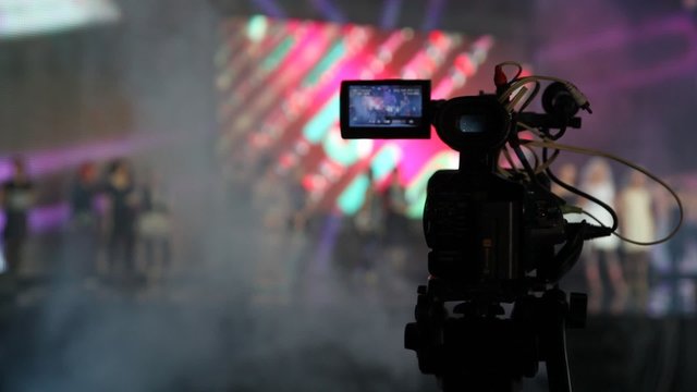professional camera which records concert in illuminated hall