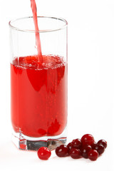 In a glass pours the cranberry juice