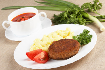Cutlet with mashed potatoes and soup
