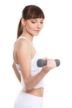 A young and fit brunette Caucasian woman with dumbbels