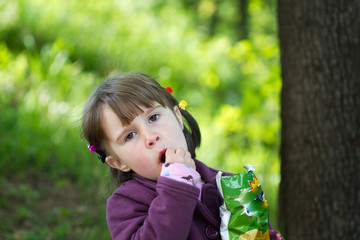 Little girl eating chips