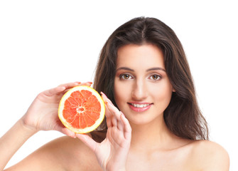 Portrait of a young Caucasian woman holding a fresh grapefruit