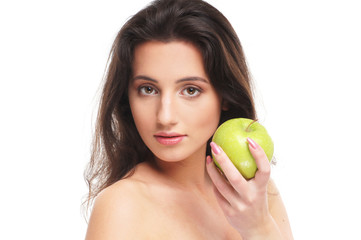 Portrait of a young and cute woman with a fresh green apple