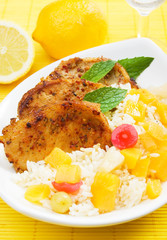 Carribean style pork loin chops with rice and tropical fruit