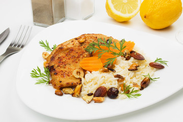 Spicy pork steaks with roasted nuts and rice