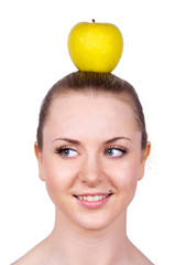 Portrait of cheerful woman with apple on her head