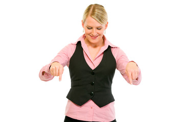 Smiling modern business woman pointing down isolated on white.