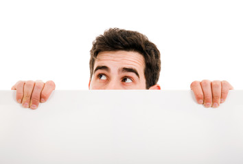 Portrait of a young guy holding blank billboard