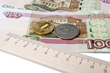 coins, banknotes and a ruler - the concept of the ruble  rate
