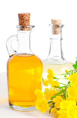 two bottles of oil with a flower buttercup
