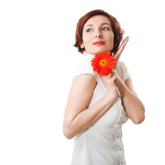 Beautiful woman with flower gerbera in her hands against white b