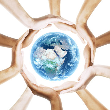 Earth with multiracial human hands around it